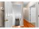 Hallway featuring hardwood floors with access to carpeted stairway and additional rooms at 110 Woodland Rd, Fayetteville, GA 30214