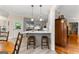 Open kitchen with breakfast bar, stainless steel appliances, and bright lighting at 110 Woodland Rd, Fayetteville, GA 30214