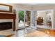Elegant living room featuring hardwood floors, fireplace, and french doors leading to an outdoor patio at 110 Woodland Rd, Fayetteville, GA 30214