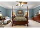 Spacious main bedroom with four-poster bed, sitting area, and lots of natural light at 110 Woodland Rd, Fayetteville, GA 30214