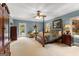 Spacious main bedroom with sitting area, carpeted floor, ceiling fan, and outdoor views at 110 Woodland Rd, Fayetteville, GA 30214