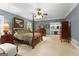 Comfortable main bedroom with a four-poster bed, ceiling fan, and private bathroom at 110 Woodland Rd, Fayetteville, GA 30214