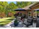 Patio with a table, seating, and manicured landscaping at 110 Woodland Rd, Fayetteville, GA 30214