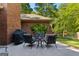 Cozy patio featuring a seating area, grill, and brickwork at 110 Woodland Rd, Fayetteville, GA 30214
