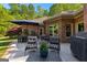 Charming patio with seating, landscaping, and outdoor grill at 110 Woodland Rd, Fayetteville, GA 30214
