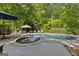 Backyard pool and jacuzzi featuring a gazebo and mature trees in the background at 110 Woodland Rd, Fayetteville, GA 30214