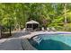 Relaxing pool area featuring a gazebo and poolside lounge chairs at 110 Woodland Rd, Fayetteville, GA 30214