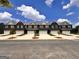 Modern townhome exteriors with brick facade, gray roofs, and white garages under a bright blue sky at 240 Epping Dr, Stockbridge, GA 30281