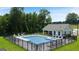 Community pool featuring a bath house, sun loungers, and a secure fence, perfect for relaxation at 240 Epping Dr, Stockbridge, GA 30281