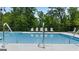 Community pool displaying safety railing and loungers providing a serene outdoor amenity at 240 Epping Dr, Stockbridge, GA 30281