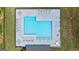 Aerial view of a community pool with lounge chairs and tables surrounding the bright blue water at 240 Epping Dr, Stockbridge, GA 30281