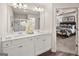 Elegant bathroom featuring double sinks, white cabinets, and a view into the bedroom at 240 Epping Drive, Stockbridge, GA 30281