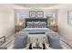 Inviting bedroom featuring a tray ceiling, stylish furnishings, and soft carpet at 240 Epping Drive, Stockbridge, GA 30281