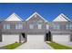 Modern townhome with a brick facade, symmetrical windows, and attached garages at 240 Epping Drive, Stockbridge, GA 30281
