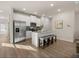 Bright kitchen features stainless steel appliances, white cabinets, and a large island with seating at 240 Epping Drive, Stockbridge, GA 30281
