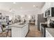 Open kitchen showcasing a center island with granite countertops and stainless steel appliances at 240 Epping Drive, Stockbridge, GA 30281