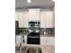 Well-equipped kitchen features stainless steel appliances, granite countertops, and white cabinetry at 240 Epping Drive, Stockbridge, GA 30281