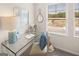 Bright office space with a glass desk, tasteful decor, and natural light from the window at 240 Epping Drive, Stockbridge, GA 30281