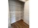 Spacious walk-in pantry with white wire shelving and wood-look flooring for organized storage at 240 Epping Drive, Stockbridge, GA 30281