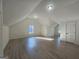 Unfinished attic or bonus room with hardwood floors, neutral walls and natural light streaming in from the windows at 150 Park Timbers Drive, Sharpsburg, GA 30277