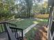 View from the deck to the backyard with mature trees and stepping stone pathway at 150 Park Timbers Drive, Sharpsburg, GA 30277