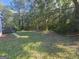 Large backyard with a wood deck and mature trees providing shade and privacy at 150 Park Timbers Drive, Sharpsburg, GA 30277