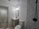 Newly renovated bathroom showcasing the vanity, toilet, and newly tiled tub at 150 Park Timbers Drive, Sharpsburg, GA 30277