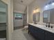 Modern bathroom with a double sink vanity, marble countertops, and a spacious glass-enclosed shower at 150 Park Timbers Drive, Sharpsburg, GA 30277