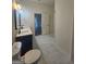 Bright bathroom featuring a toilet, a sink with marble countertops, and sleek floor tiles throughout at 150 Park Timbers Drive, Sharpsburg, GA 30277