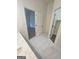 Bathroom featuring sleek floor tiles, a view to the bedroom, and a walk-in closet with an open door at 150 Park Timbers Drive, Sharpsburg, GA 30277