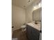 Stylish half bathroom features a gray vanity with white countertop and modern fixtures at 150 Park Timbers Drive, Sharpsburg, GA 30277