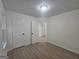 Bedroom features neutral walls, hardwood floors, bright windows, and doorways to other rooms at 150 Park Timbers Drive, Sharpsburg, GA 30277