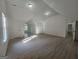 Spacious bonus room featuring light-colored walls, hardwood flooring, and abundant natural light at 150 Park Timbers Drive, Sharpsburg, GA 30277