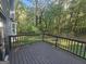 Spacious wooden deck with railing offering a view of the backyard and surrounding trees at 150 Park Timbers Drive, Sharpsburg, GA 30277