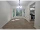 This dining room features a large bay window, modern lighting, and seamless flow into the kitchen at 150 Park Timbers Drive, Sharpsburg, GA 30277
