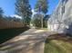 Long driveway leading to a two-car garage, with the house nestled among mature trees, offering privacy at 150 Park Timbers Drive, Sharpsburg, GA 30277