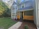 Home exterior featuring a classic design with a well-kept lawn and a welcoming front porch at 150 Park Timbers Drive, Sharpsburg, GA 30277