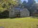 Beautiful two-story home with a well-maintained lawn and inviting curb appeal with mature trees at 150 Park Timbers Drive, Sharpsburg, GA 30277