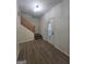 Inviting foyer with wood-look floors, staircase, and a front door with oval window at 150 Park Timbers Drive, Sharpsburg, GA 30277