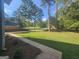 Expansive front yard with lush greenery, framed by mature trees, creating a serene and inviting outdoor space at 150 Park Timbers Drive, Sharpsburg, GA 30277