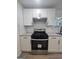 Close up shot of the new stainless steel range in the kitchen with granite countertops and white cabinets at 150 Park Timbers Drive, Sharpsburg, GA 30277