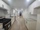 Modern kitchen featuring stainless steel appliances, granite countertops, and an open layout leading to the living space at 150 Park Timbers Drive, Sharpsburg, GA 30277