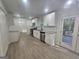 Spacious and updated kitchen with granite countertops, white cabinets, stainless steel dishwasher and new flooring at 150 Park Timbers Drive, Sharpsburg, GA 30277