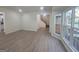 Spacious living room features natural light, modern floors, and an open floor plan leading to the staircase at 150 Park Timbers Drive, Sharpsburg, GA 30277