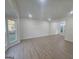 Bright and open living room with wood-look floors and natural light from large windows at 150 Park Timbers Drive, Sharpsburg, GA 30277