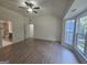 Spacious main bedroom featuring luxury vinyl plank flooring, a ceiling fan and natural light from the windows at 150 Park Timbers Drive, Sharpsburg, GA 30277