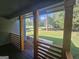 Covered porch with wood columns and railing, offering a peaceful view of the spacious front yard at 150 Park Timbers Drive, Sharpsburg, GA 30277