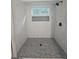 Beautifully tiled shower with a mosaic-tiled shower floor, shower niche, and a window bringing in natural light at 150 Park Timbers Drive, Sharpsburg, GA 30277