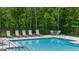 Relaxing community pool featuring lounge chairs and a wooded backdrop for a private feel at 256 Epping Dr, Stockbridge, GA 30281