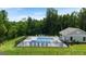 Community pool featuring lounge chairs and a fully fenced perimeter in a lush, green setting at 256 Epping Dr, Stockbridge, GA 30281